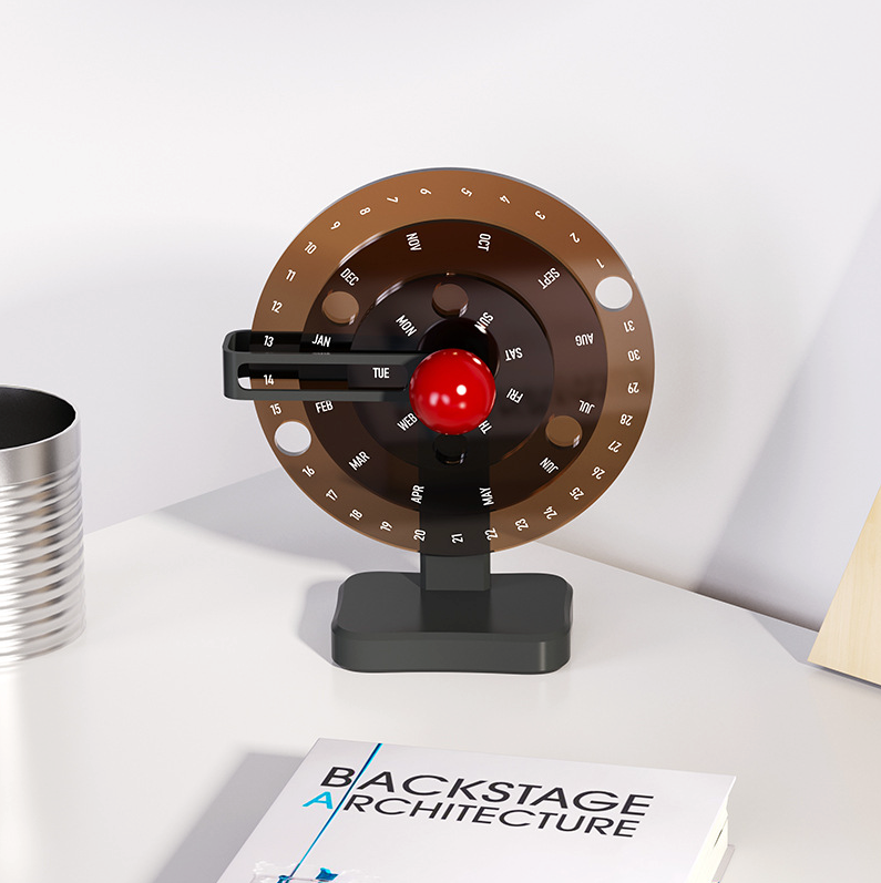 calendrier rotatif couleur foncé 3 cercles sur un coin de bureau avec un livre d'architecture