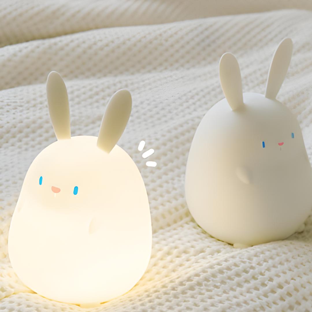 2 veilleuses lapin blanc posées sur une couverture gauffrée blanche