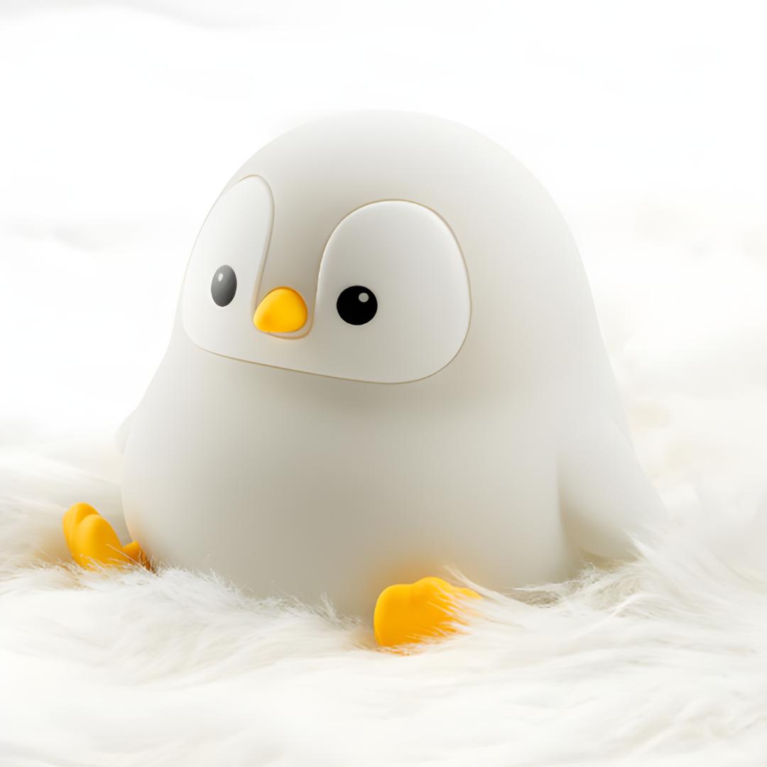 veilleuse originale en forme de pingouin assis éteinte et posée sur un tapis à poils blancs