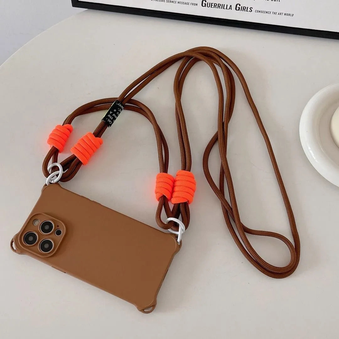 Flatlay sur fond blanc : coque marron montée avec le cordon marron à attaches orange
