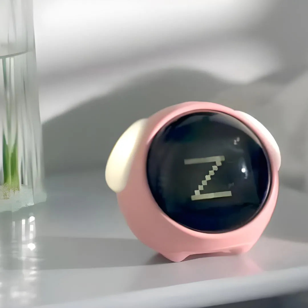Réveil interactif rose affichant une icône “Z” pour indiquer le sommeil