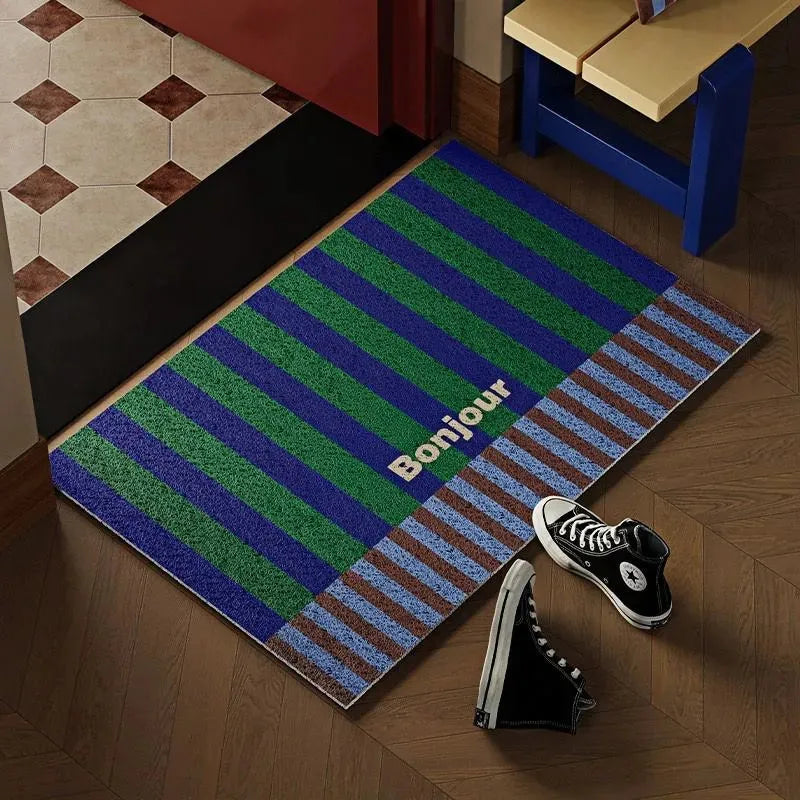Tapis de bienvenue Bonjour en PVC à l’entrée d’un appartement, style graphique coloré